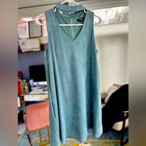 Suede-like cocktail dress with cut out neck line and fun swing